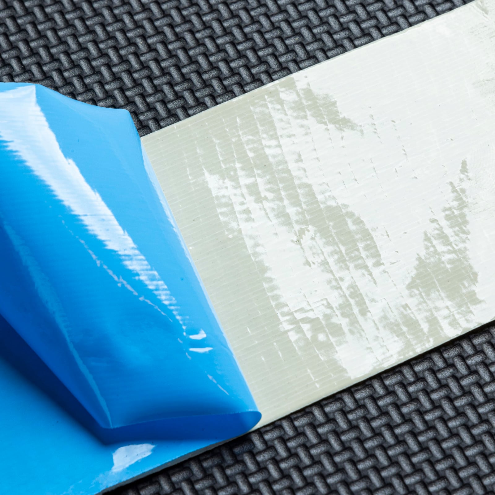 A roll of SimTurf double-sided turf tape with its packaging