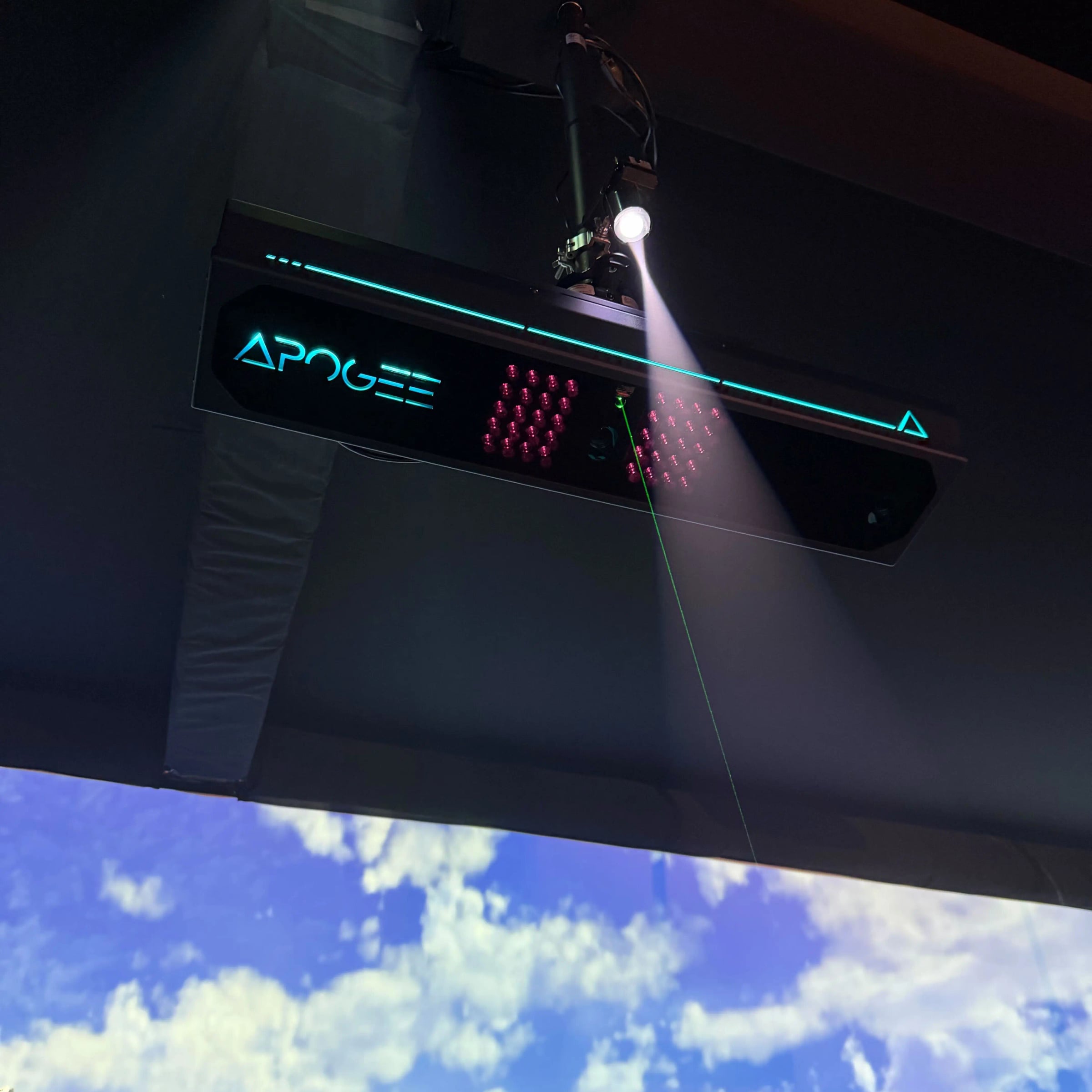 TruGolf Apogee ceiling-mounted above a hitting bay