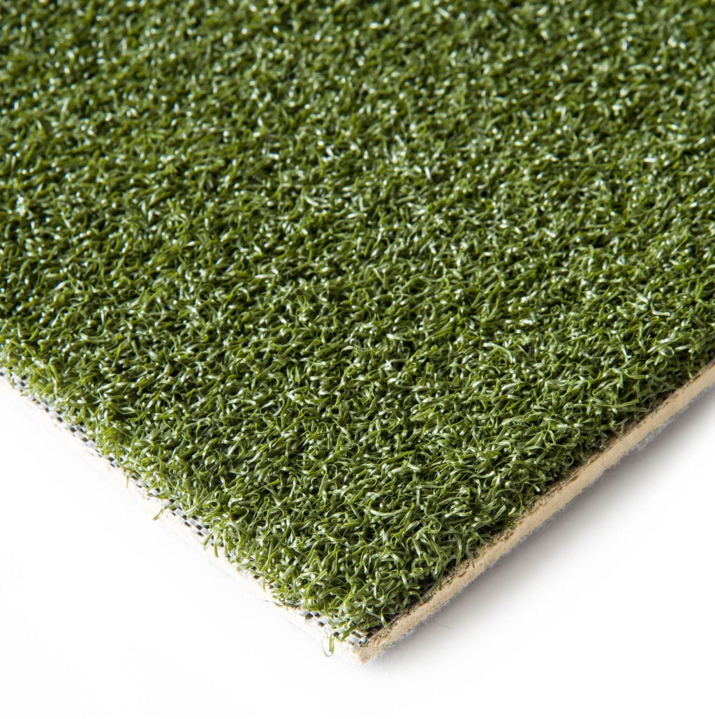 TFD Golf Sim Pro turf on white with the corner lifted to show the tan 5mm foam backing