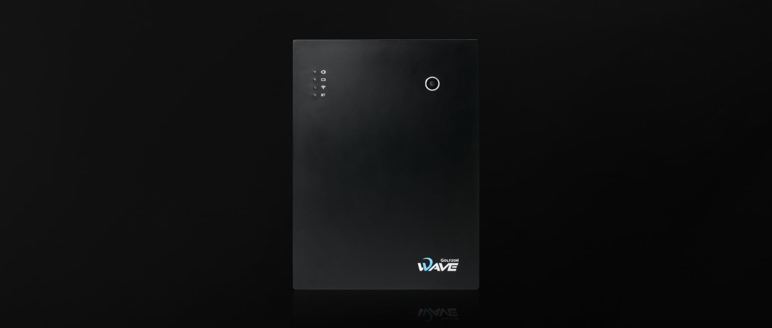 Golfzon WAVE portable radar launch monitor, front elevation on a dark studio floor