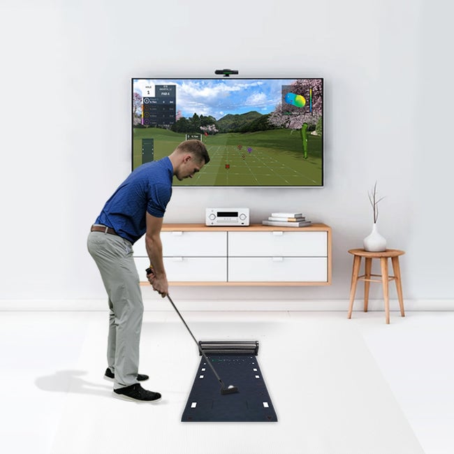 A golfer putting on the Exputt RG mat, with the sensor mounted above a screen showing the putting simulation